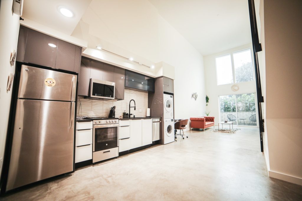 a kitchen with a refrigerator and microwave
