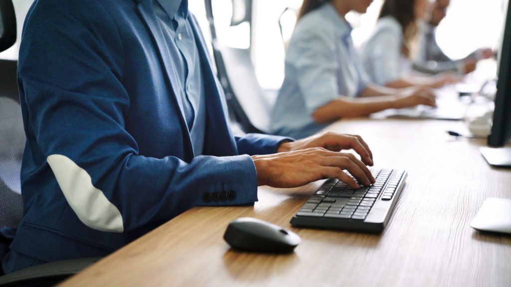 a person in a suit using a laptop