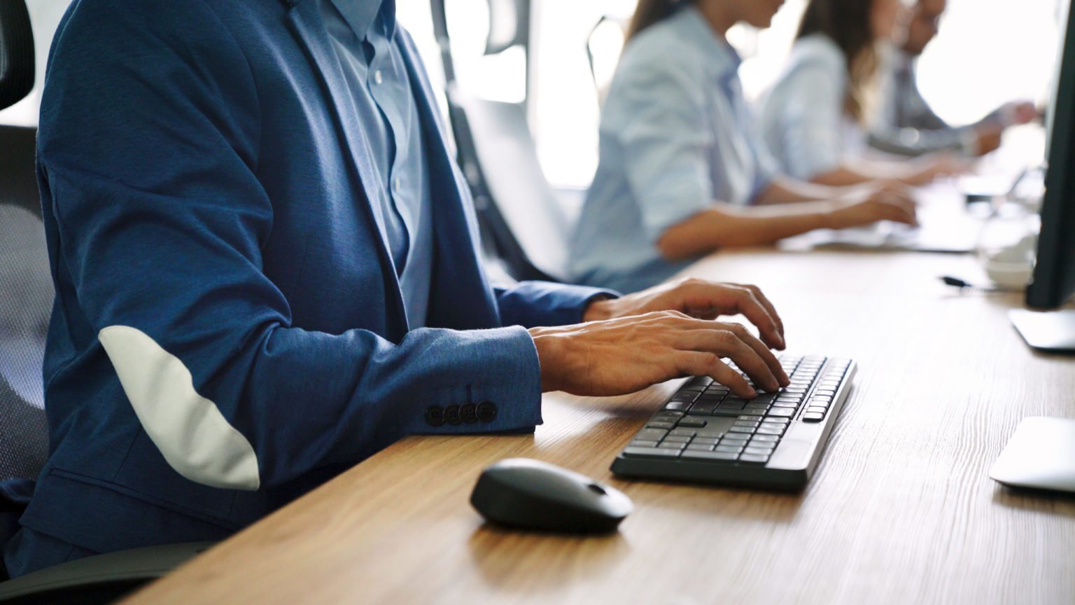 a person in a suit using a laptop