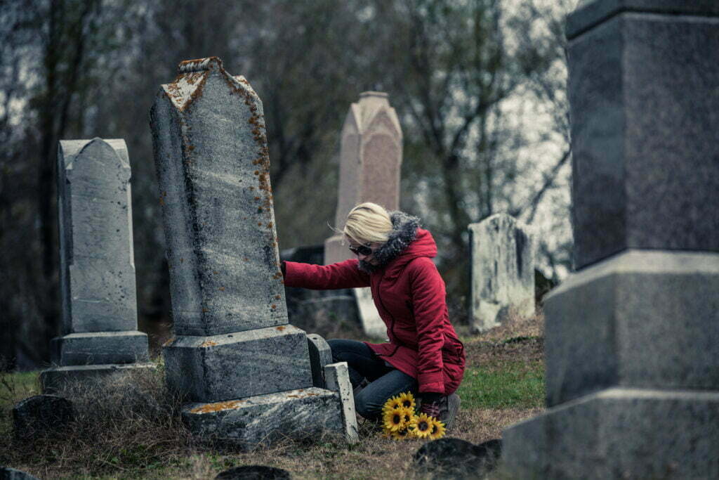 sad woman in mourning touching a loved one s grave 2021 08 26 15 42 28 utc scaled